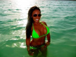 Abbee Kimberly in ocean wearing wet fluorescent green bikini