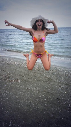 MFC CuteHerminie in bikini jumping in the air at the beach