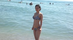 MFC’s QueenofTrolls in ocean wearing zebra print bikini